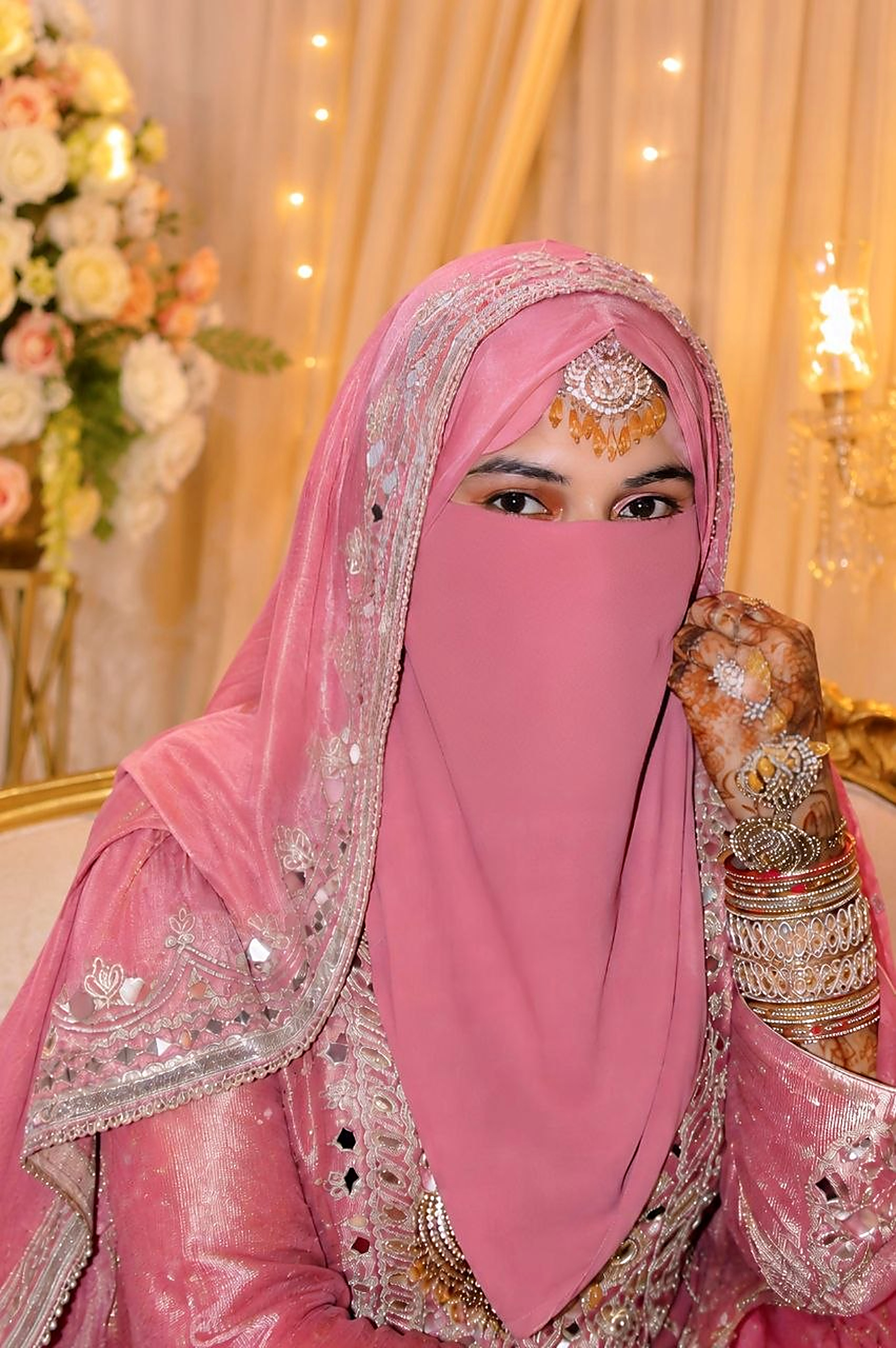 Bride Samina in a pink veil at the ceremony