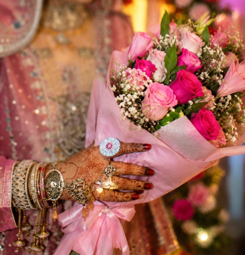 Bride holding a bouquet of pink and white roses